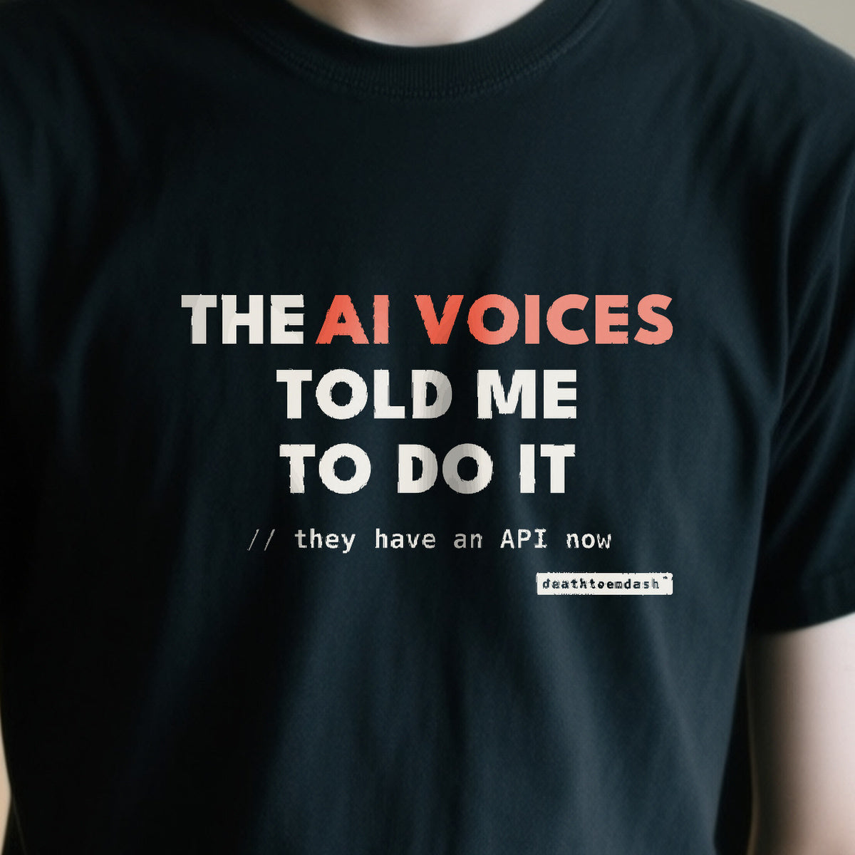 Ai Voices Told Me design shown close up on a black unisex t-shirt