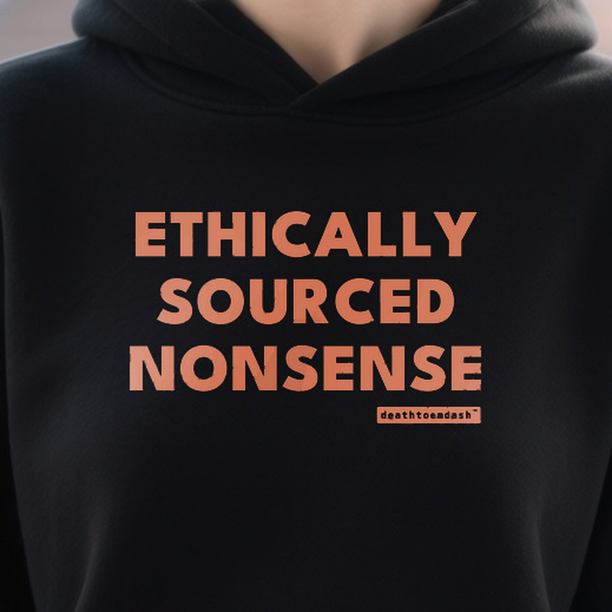 Ethically Sourced Nonsense design shown close up on a black unisex hoodie