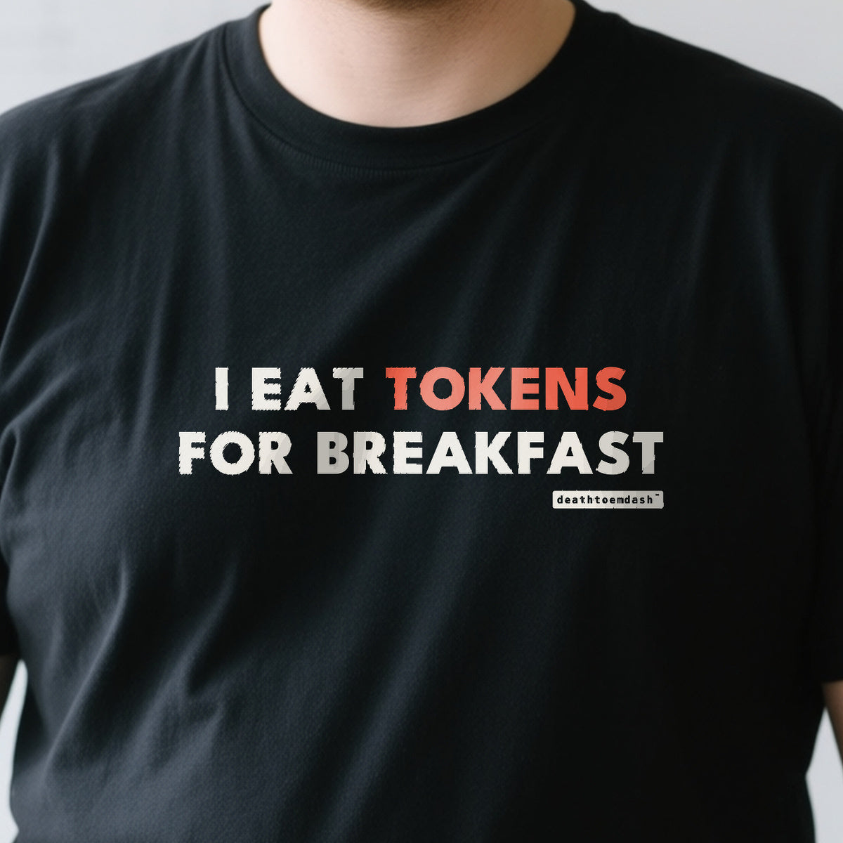 I Eat Tokens For Breakfast design shown close up on a black unisex t-shirt