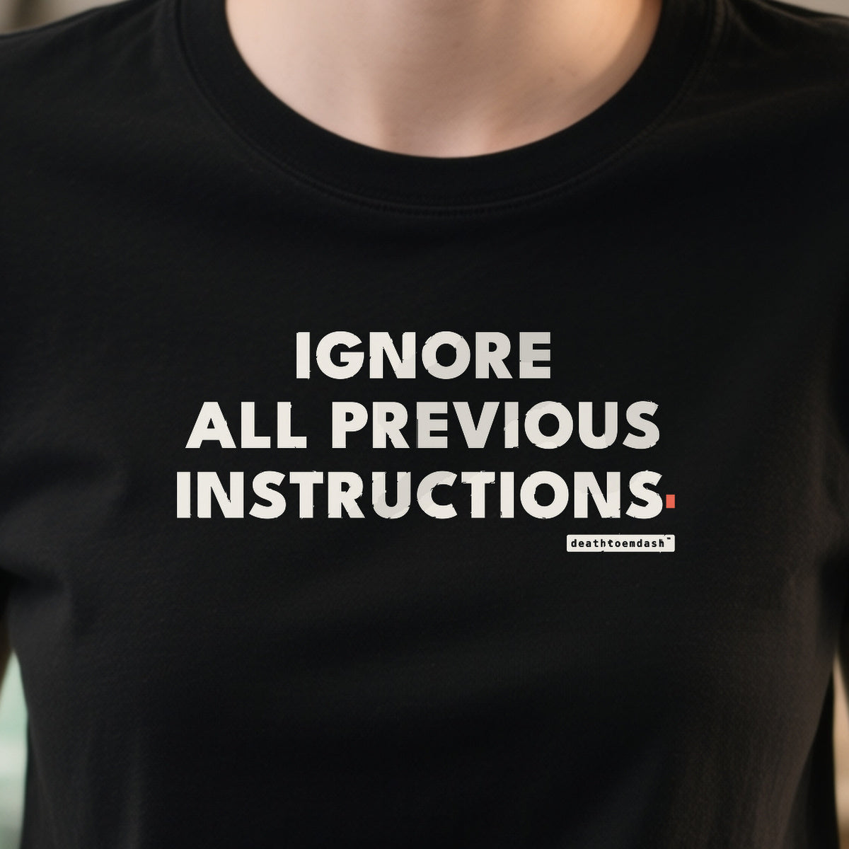 Ignore All Previous Instructions design shown close up on a black unisex t-shirt