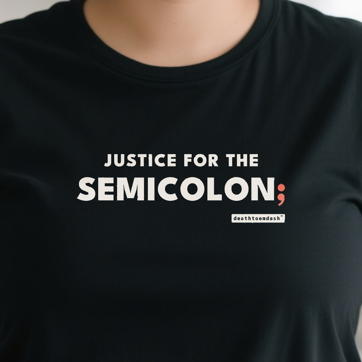 Justice For The Semicolon design shown close up on a black unisex t-shirt