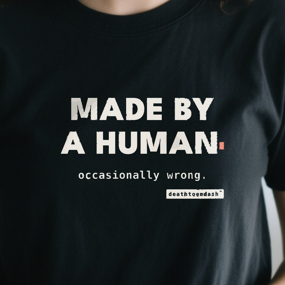 Made By A Human Occasionally Wrong design shown close up on a black unisex t-shirt