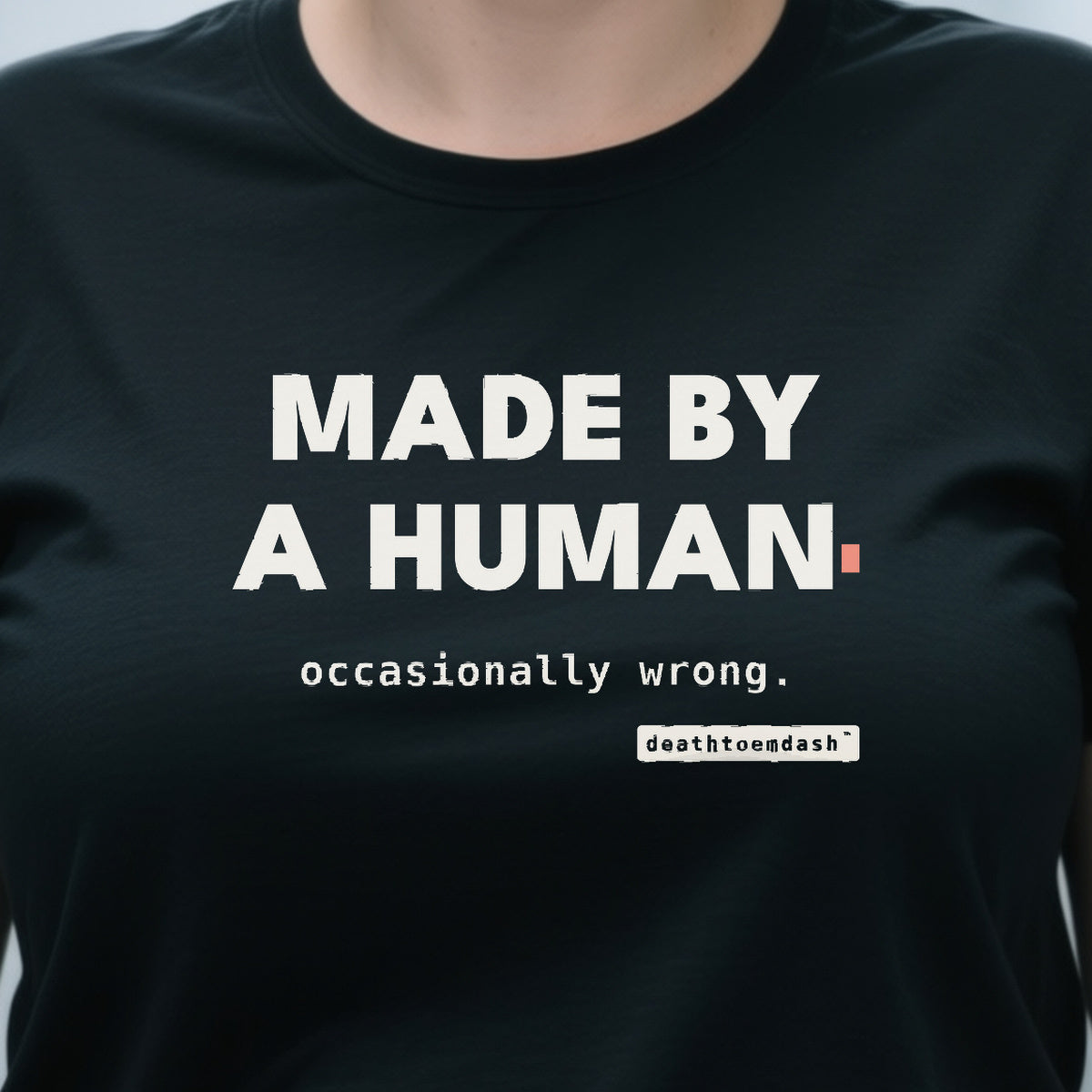 Made By A Human Occasionally Wrong design shown close up on a black unisex t-shirt