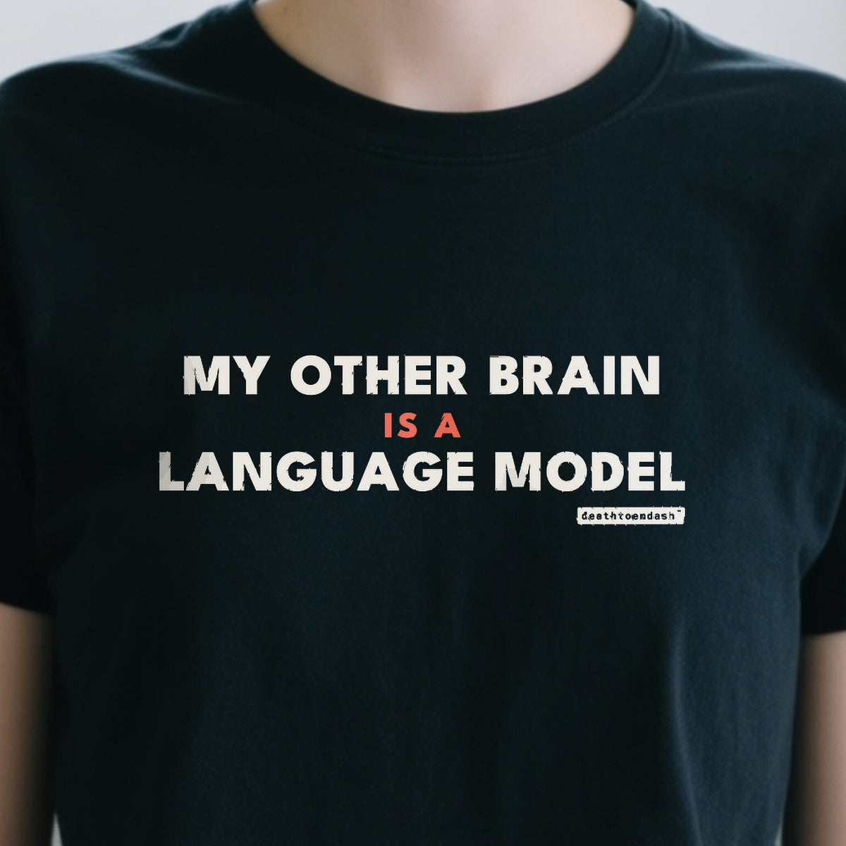 My Other Brain Is A Language Model design shown close up on a black unisex t-shirt
