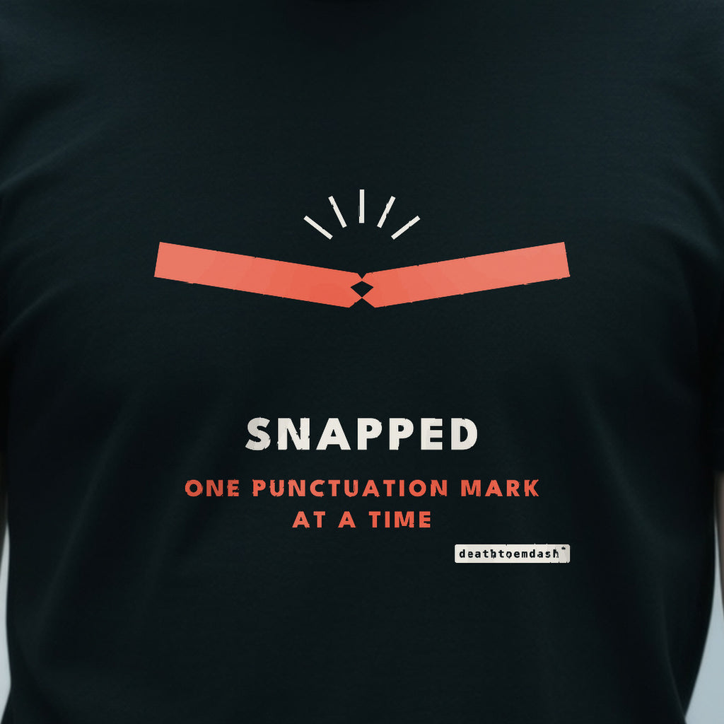 Snapped design shown close up on a black unisex t-shirt