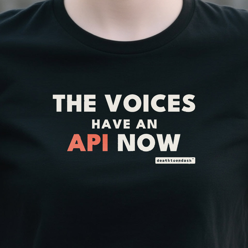 The Voices Have An Api Now design shown close up on a black unisex t-shirt