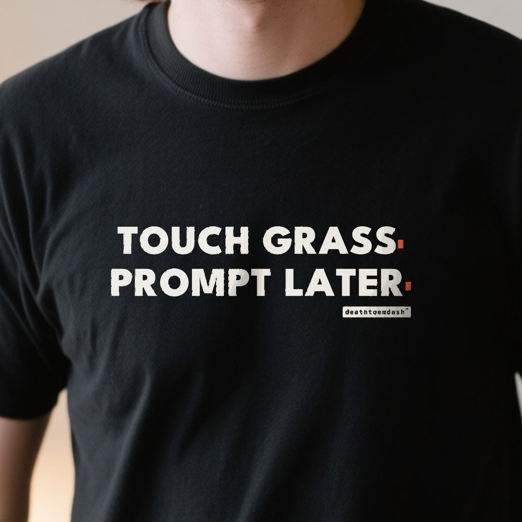 Touch Grass Prompt Later design shown close up on a black unisex t-shirt