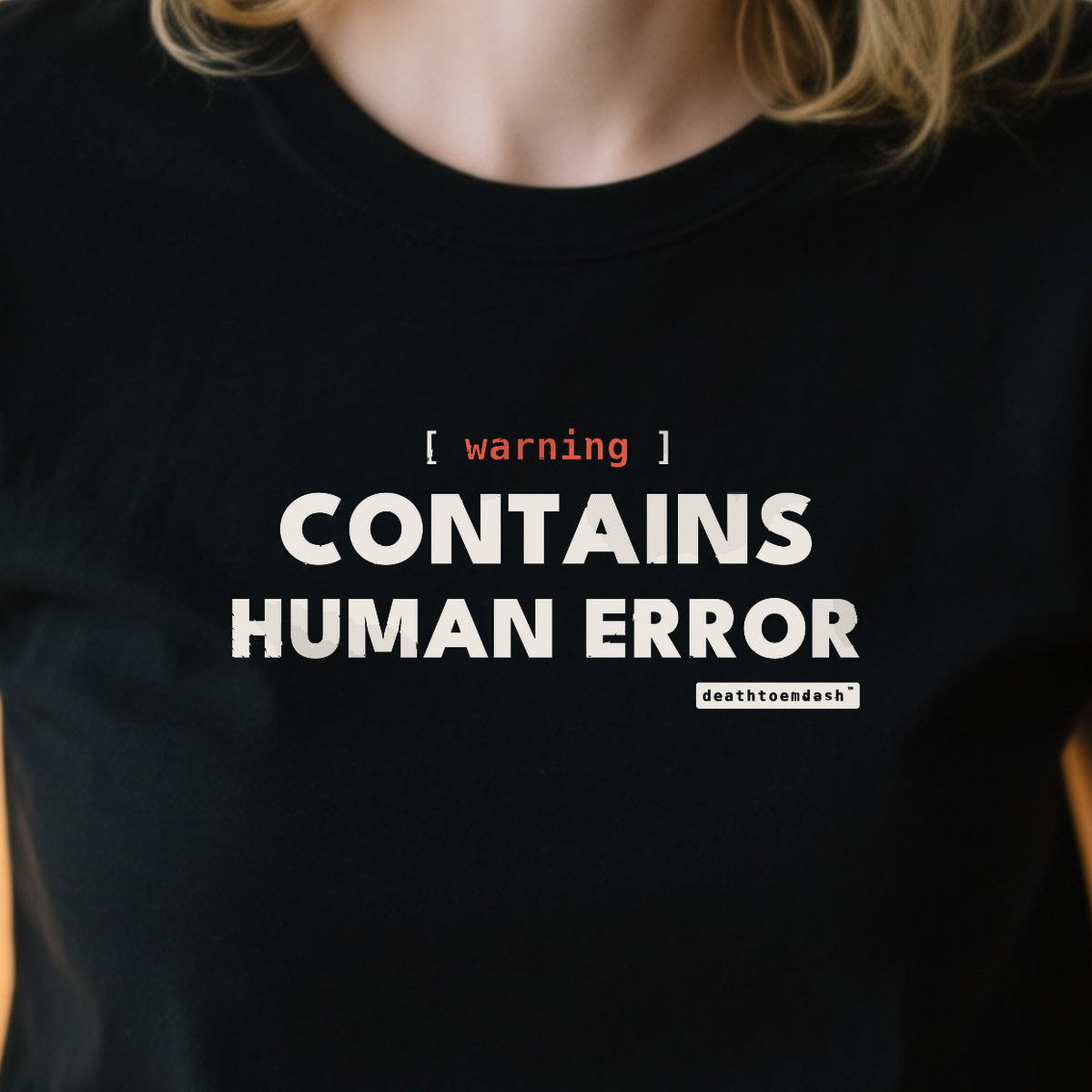Warning Contains Human Error design shown close up on a black unisex t-shirt