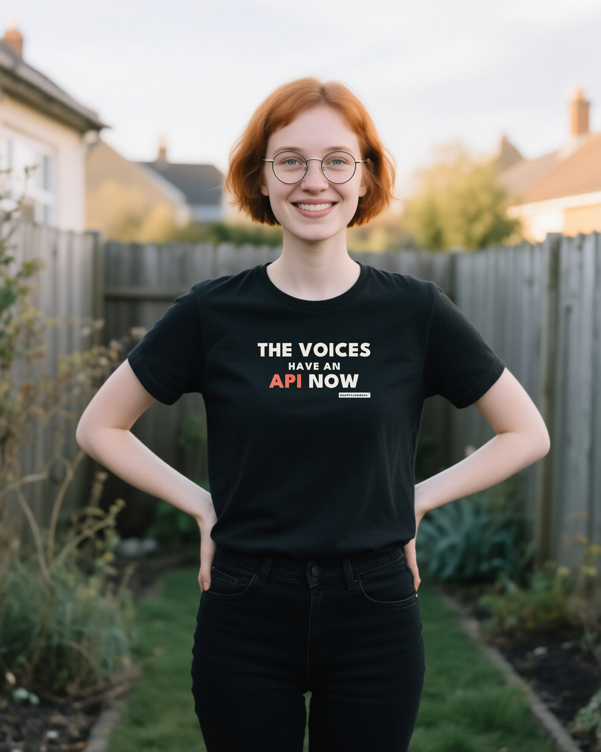 The Voices Have An Api Now unisex heavyweight t-shirt in black, worn