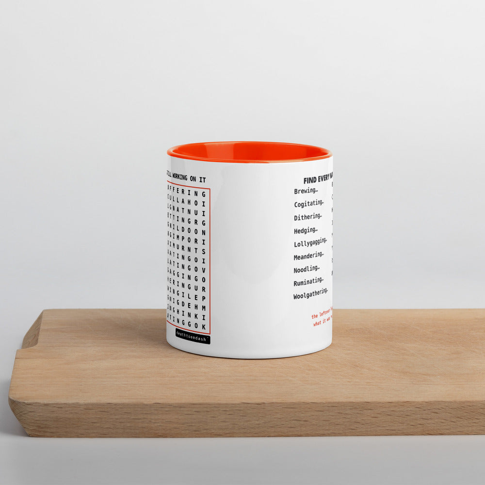 Another view of the mug, orange handle and interior