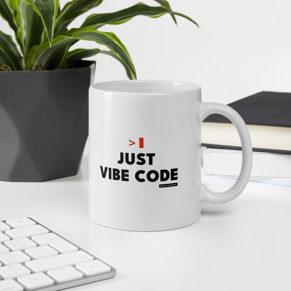 Just Vibe Code mug in an office setting